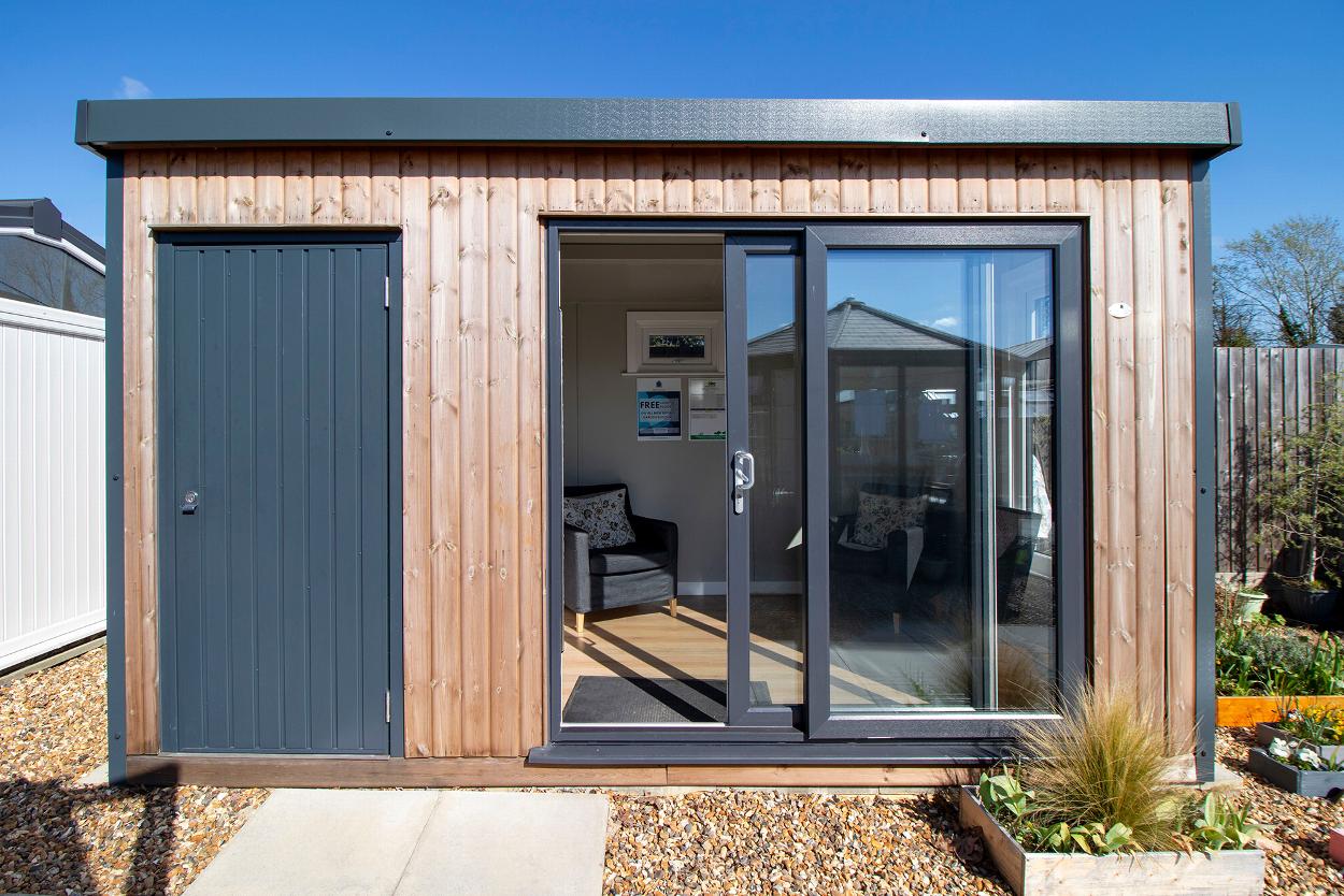 Timber-clad garden office with sliding doors